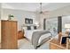 Bedroom featuring king bed, ceiling fan, and patio access that leads to outdoor seating area at 344 Cascade Ln, Palm Harbor, FL 34684