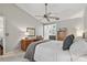 Bright bedroom with ceiling fan, desk, dresser, and ensuite bathroom at 344 Cascade Ln, Palm Harbor, FL 34684