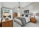Bright bedroom with a comfortable king bed, ceiling fan, natural lighting, and ensuite bathroom at 344 Cascade Ln, Palm Harbor, FL 34684