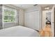 Bright bedroom features a ceiling fan, a window with curtains, a bed with white linens, and a closet at 344 Cascade Ln, Palm Harbor, FL 34684
