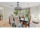 Dining room with wood table seating four, light fixture, view to the back yard through glass doors at 344 Cascade Ln, Palm Harbor, FL 34684