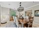 Inviting dining room with wood table and seating for six under a decorative metal chandelier at 344 Cascade Ln, Palm Harbor, FL 34684