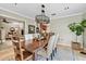 Dining room with wood table and seating for six under modern chandelier and a fiddle leaf fig at 344 Cascade Ln, Palm Harbor, FL 34684