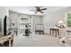 Bright exercise room featuring a ceiling fan, carpet flooring, a window, and various workout machines for a home gym experience at 344 Cascade Ln, Palm Harbor, FL 34684