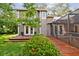 Two-story home with a well-manicured lawn, a wooden walkway, and a screened-in patio at 344 Cascade Ln, Palm Harbor, FL 34684