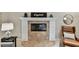 Close-up of fireplace with decorative tile surround and mantle, next to a leather chair at 344 Cascade Ln, Palm Harbor, FL 34684