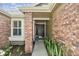 Close-up of front entrance with brick columns and lush landscaping at 344 Cascade Ln, Palm Harbor, FL 34684