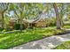 This attractive single-Gathering home has a well-manicured lawn, mature trees, and a two-car garage at 344 Cascade Ln, Palm Harbor, FL 34684