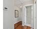 Hallway with wood floors, white trim, and view to additional room at 344 Cascade Ln, Palm Harbor, FL 34684