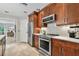This kitchen features stainless steel appliances, wooden cabinets, and neutral countertops and backsplash at 344 Cascade Ln, Palm Harbor, FL 34684