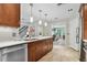 Bright kitchen featuring tile floors, wood cabinets, white countertops and stainless steel appliances at 344 Cascade Ln, Palm Harbor, FL 34684
