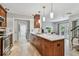Spacious kitchen with a central island, warm wood cabinetry, and modern pendant lighting at 344 Cascade Ln, Palm Harbor, FL 34684