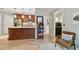 Open kitchen featuring a center island, wood cabinets and stainless appliances and tile flooring at 344 Cascade Ln, Palm Harbor, FL 34684