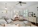 Cozy living room featuring hardwood floors, plantation shutters, and comfortable seating at 344 Cascade Ln, Palm Harbor, FL 34684