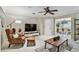 Bright and inviting living room with views into the dining area, featuring a chair and TV at 344 Cascade Ln, Palm Harbor, FL 34684