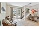 Inviting living room with tile flooring, French doors to the patio, and a staircase to the upper level at 344 Cascade Ln, Palm Harbor, FL 34684