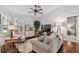 Comfortable living room boasting hardwood floors, plantation shutters, and neutral furnishings at 344 Cascade Ln, Palm Harbor, FL 34684