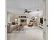 Bright living room with a decorative fireplace, neutral furniture, and ceiling fan at 344 Cascade Ln, Palm Harbor, FL 34684