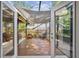 Screened-in patio with a wooden floor is framed with a partial covering at 344 Cascade Ln, Palm Harbor, FL 34684