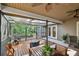 Inviting covered patio featuring an outdoor dining area and screened enclosure, ideal for relaxing and entertaining at 344 Cascade Ln, Palm Harbor, FL 34684