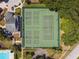 Aerial view of well-maintained tennis courts within the community at 344 Cascade Ln, Palm Harbor, FL 34684