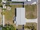 Overhead view of a home with fenced in yard including a fire pit, outdoor patio and a paved driveway at 3490 57Th St, St Petersburg, FL 33710