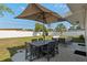 Spacious backyard with patio, dining set under umbrella, and well-manicured lawn at 3490 57Th St, St Petersburg, FL 33710