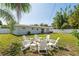Backyard featuring a fire pit with Adirondack chairs surrounded by a large grassy area at 3490 57Th St, St Petersburg, FL 33710