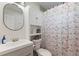 Cozy bathroom featuring a vanity with sink, toilet, and shower with patterned curtain at 3490 57Th St, St Petersburg, FL 33710