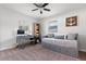 Bedroom featuring a gray daybed, work desk, and natural light from two windows at 3490 57Th St, St Petersburg, FL 33710
