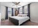 Comfortable bedroom featuring a ceiling fan, large bed, and natural light from multiple windows at 3490 57Th St, St Petersburg, FL 33710