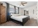 Bedroom with a dark wood bed frame, ceiling fan, and a mirrored closet door at 3490 57Th St, St Petersburg, FL 33710