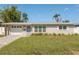 Charming single-story home featuring a well-maintained lawn and attached garage with updated driveway at 3490 57Th St, St Petersburg, FL 33710
