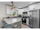 Updated kitchen with sleek appliances, stone countertops, ample cabinetry, and a convenient breakfast bar at 3490 57Th St, St Petersburg, FL 33710