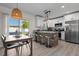 Modern kitchen featuring an island with seating, stainless steel appliances, and an adjacent dining area at 3490 57Th St, St Petersburg, FL 33710