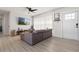 Inviting living room featuring neutral tones, wood-look floors, and a large comfortable sectional at 3490 57Th St, St Petersburg, FL 33710