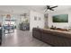 Open-concept living space featuring modern flooring, a comfortable sofa, and seamless flow to the kitchen at 3490 57Th St, St Petersburg, FL 33710