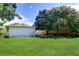 The large back yard features a wooden fence and mature trees creating a private outdoor oasis at 3910 14Th N Ave, St Petersburg, FL 33713