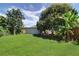 Lush backyard with green grass, mature trees, and privacy fence at 3910 14Th N Ave, St Petersburg, FL 33713