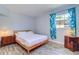 Cozy bedroom with light blue walls, wood-look flooring, and bright natural light at 3910 14Th N Ave, St Petersburg, FL 33713