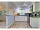 Bright kitchen features white cabinets, stainless steel appliances, and granite countertops at 3910 14Th N Ave, St Petersburg, FL 33713