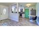 Open concept living space with wood-look floors and a view of the kitchen with stainless steel appliances at 3910 14Th N Ave, St Petersburg, FL 33713