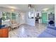 Open-concept living area showcasing wood-look flooring and modern kitchen with stainless appliances at 3910 14Th N Ave, St Petersburg, FL 33713
