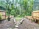 Lush backyard with a stone path, bordered by wooden fencing and dense greenery at 4006 Huxford Ct, Tampa, FL 33624