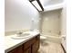 Well-lit bathroom featuring a single vanity, toilet, and a shower-tub combination at 4006 Huxford Ct, Tampa, FL 33624