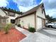 Beige two-story townhome with two car garage and shuttered windows at 4006 Huxford Ct, Tampa, FL 33624