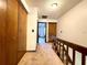 Second floor hallway featuring wall-to-wall carpeting, wood railing and a lot of closet space at 4006 Huxford Ct, Tampa, FL 33624