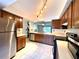 Spacious kitchen with stainless steel appliances, tiled floors, and wood cabinets at 4006 Huxford Ct, Tampa, FL 33624