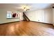 Open-concept living room with wood-look floors, ceiling fan, and kitchen view at 4006 Huxford Ct, Tampa, FL 33624