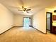 Spacious living room with carpet, ceiling fan and sliding glass door to outdoor area at 4006 Huxford Ct, Tampa, FL 33624